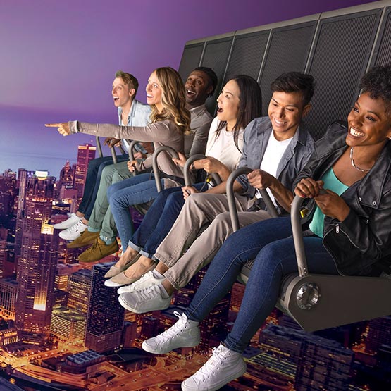 A group of riders on a flight ride superimposed over the Chicago skyline.